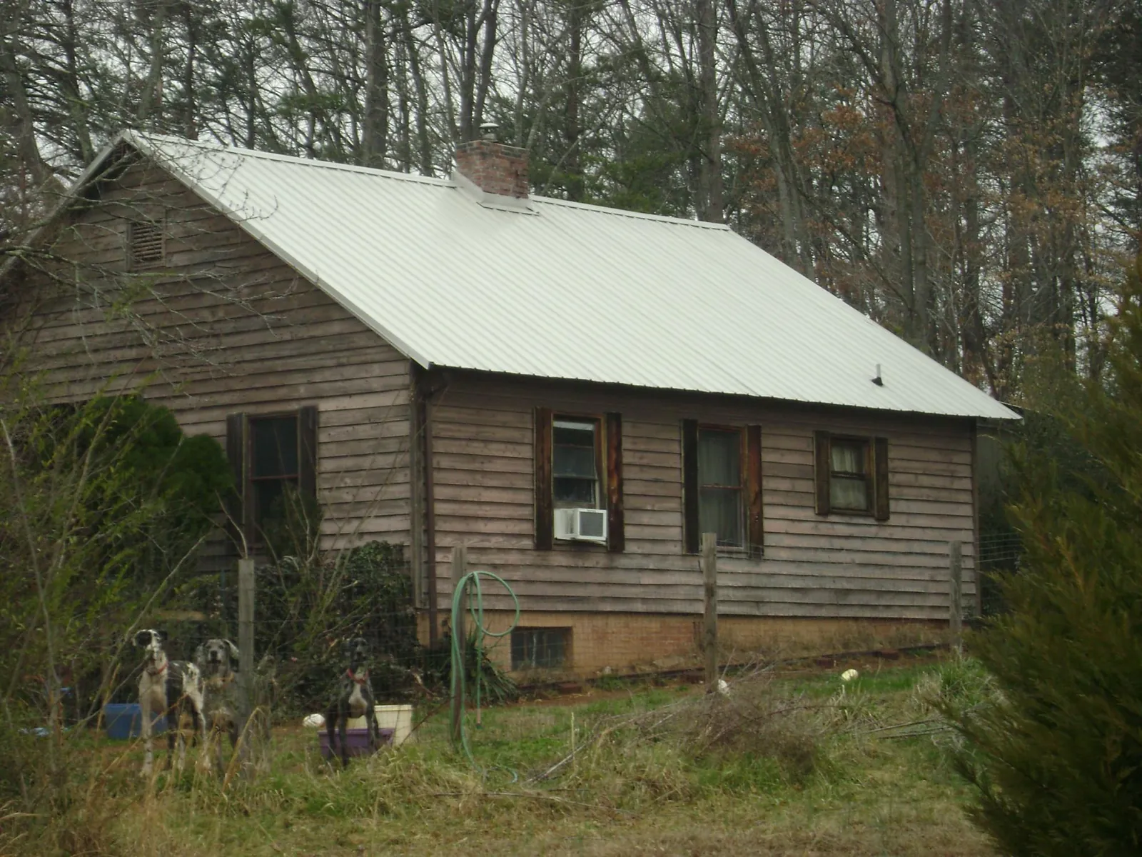 White metal roof on an old wood sided farmhouse, from a Metal Roof Installation job in University Park